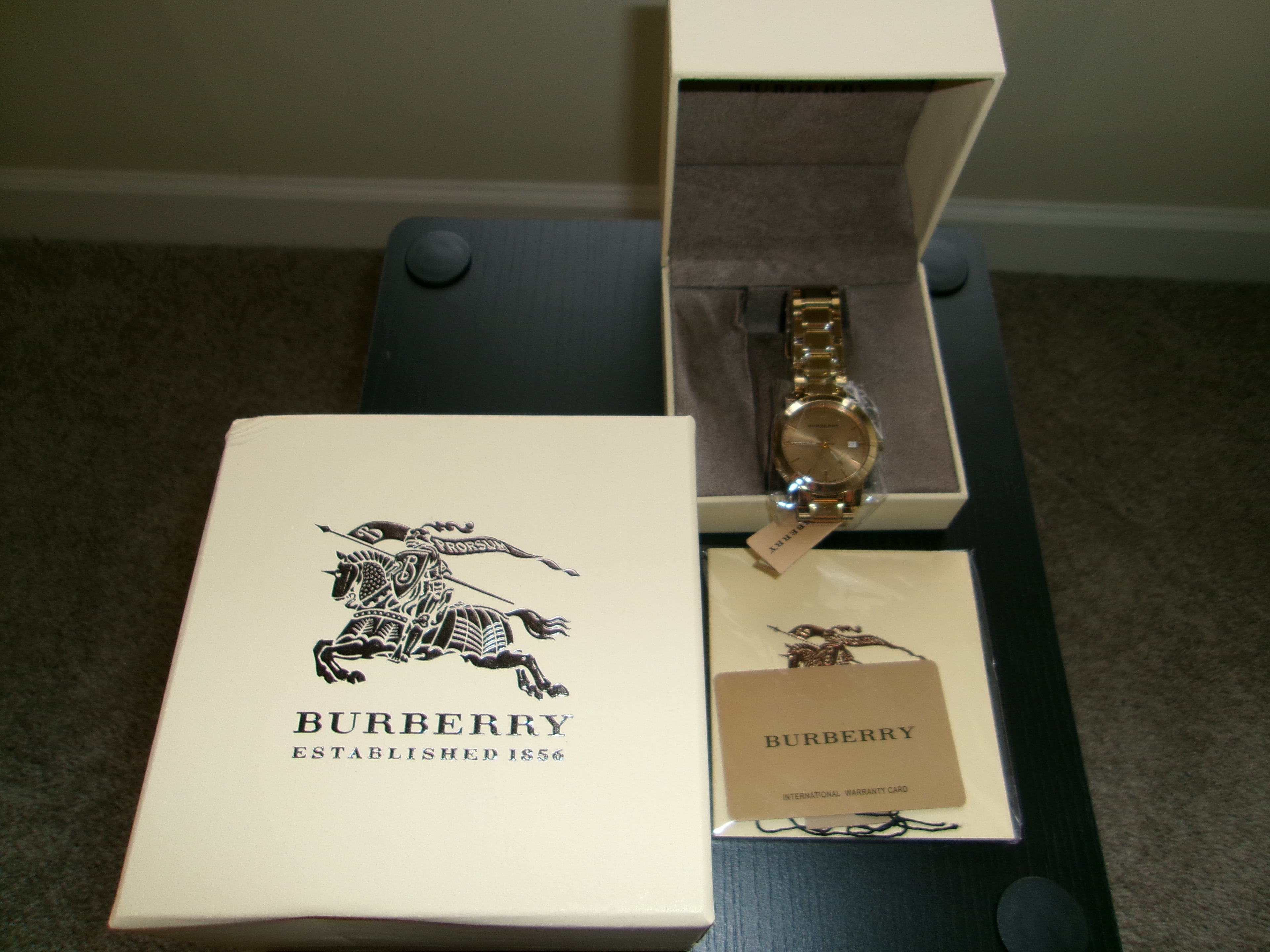 Burberry watch and packaging on a dark surface