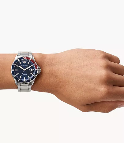Silver watch with a blue face on a wrist against a white background