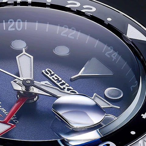 Close-up of a Seiko watch face with blue background and silver accents.