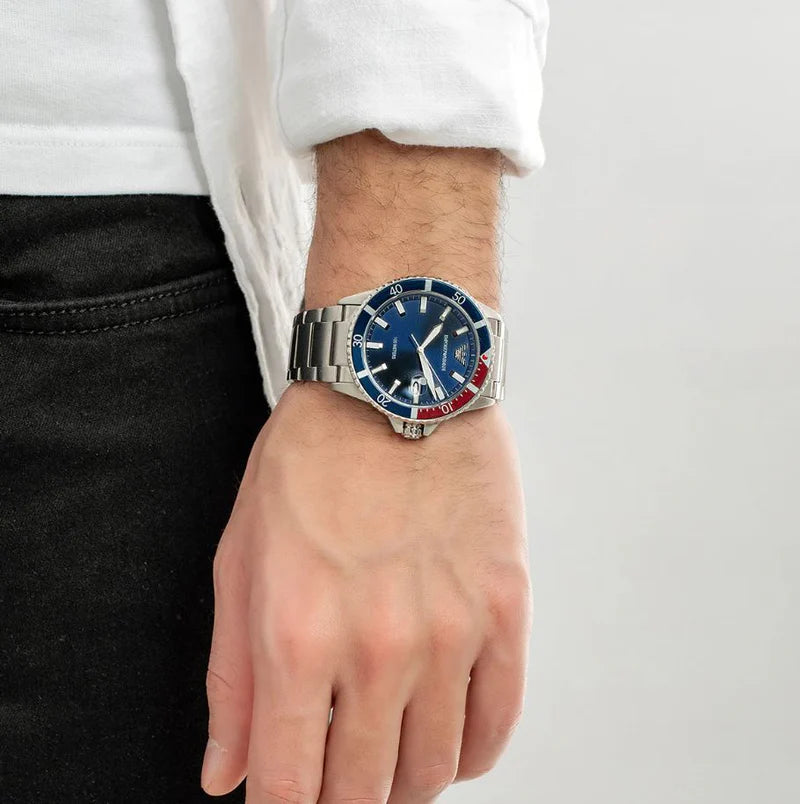 Wrist with a watch featuring a blue face and silver band.