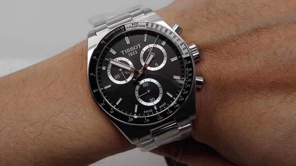 Tissot watch on a wrist with a neutral background